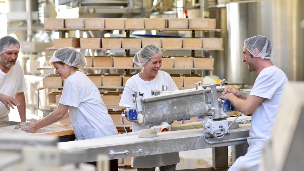 Workers on a production line that is organised by ERP with production planning